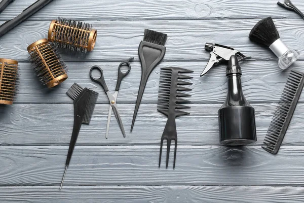 Set of hairdresser\'s tools on wooden background