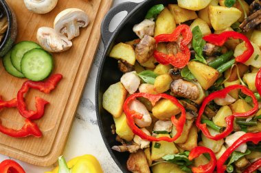 Lezzetli sebzeli tava, arka planda tavuk ve malzemeler, yakın plan.