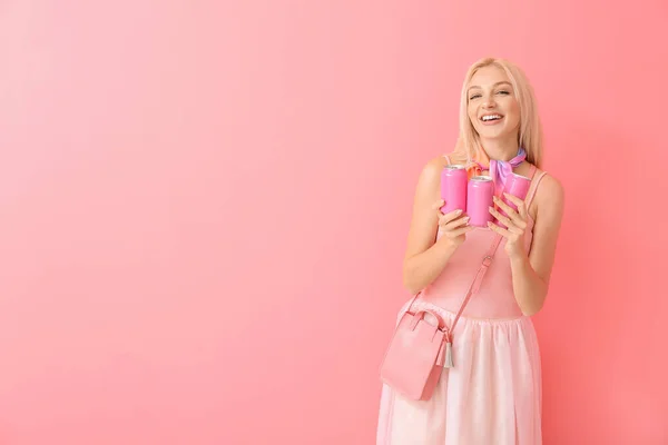 Beautiful young woman with soda on color background