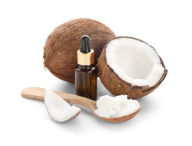 Beyaz arka planda hindistan cevizi yağlı şişe ve kaşık.