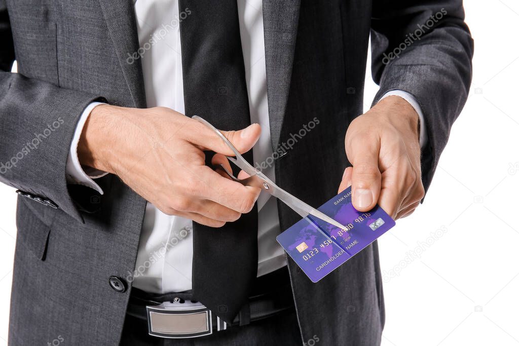 Businessman cutting credit card on white background, closeup. Bankruptcy concept