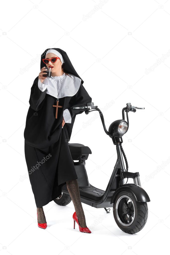 Sexy nun with scooter and alcohol on white background