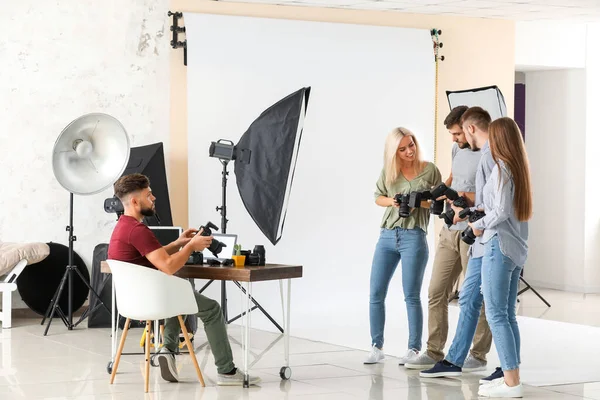 Group of young photographers in studio