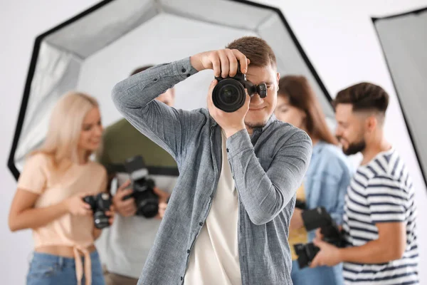 Male photographer taking picture in studio