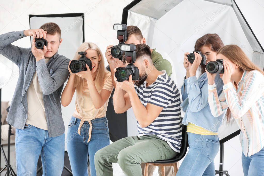 Group of young photographers in studio