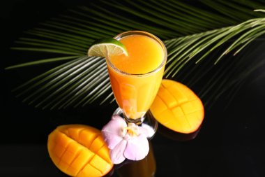 Koyu arkaplanda bir bardak lezzetli mango margaritası.