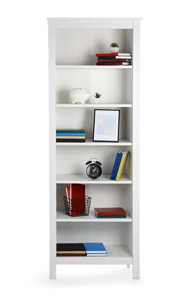 Modern shelf unit with books and decor on white background