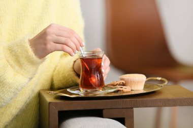 Bir fincan sıcak çay içen kadın, yakın plan.