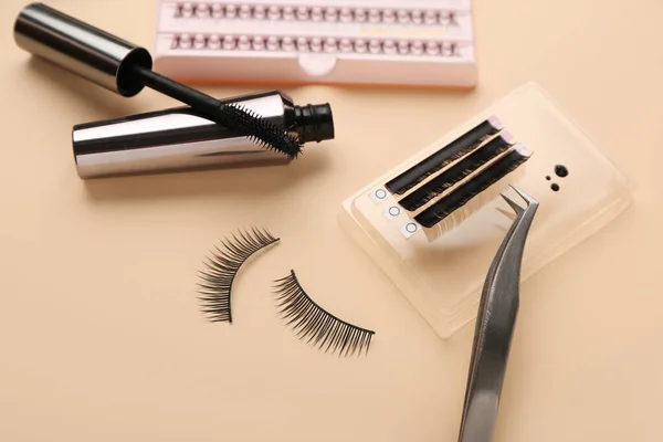 Composition with false eyelashes on color background