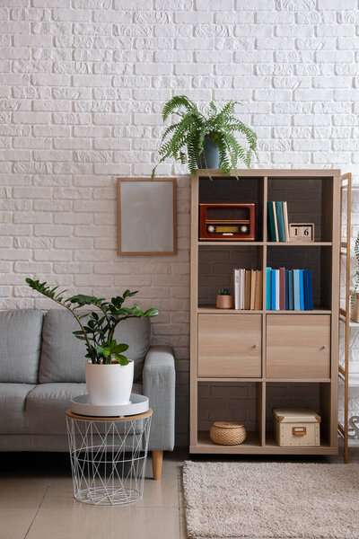 Interior of modern room with shelf unit and sofa