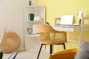 Ofisinde dizüstü bilgisayarı olan şık bir iş yeri.