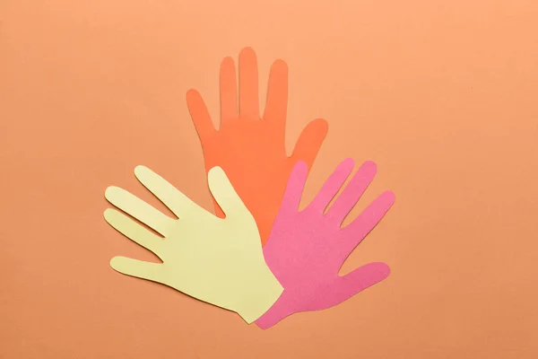 Paper human palms on color background