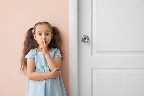 Cute Little Girl Showing Silence Gesture Closed Door — Stock Photo, Image