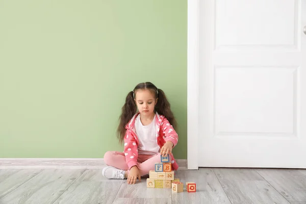 Little Girl Wooden Cubes Sitting Closed Door — Stock Photo, Image