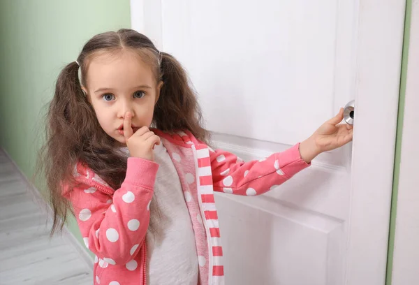 Cute Little Girl Showing Silence Gesture Closed Door — Stock Photo, Image