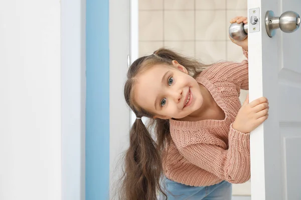Cute Little Girl Looking Out Door — Stock Photo, Image