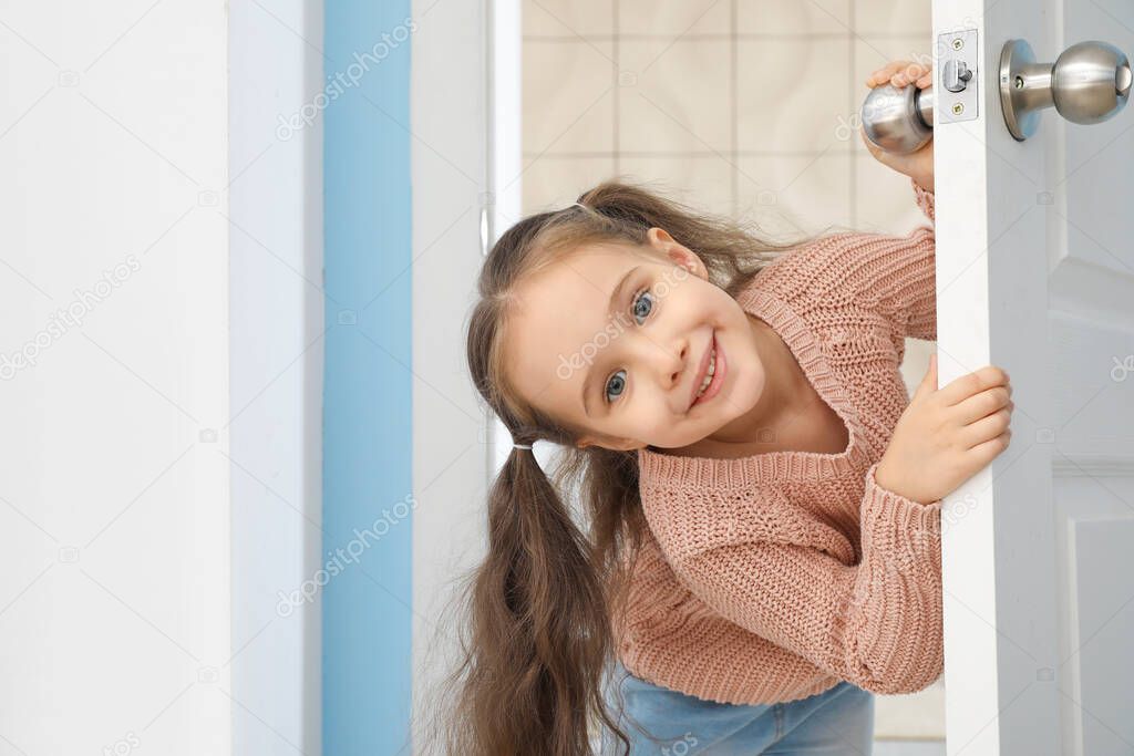 Cute little girl looking out the door