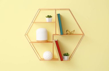 Renk duvarında kitap ve dekor asılı raflar