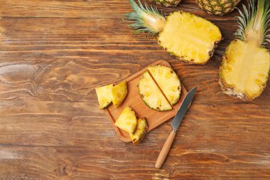 Ahşap arka planda kesilmiş taze ananas tahtası.