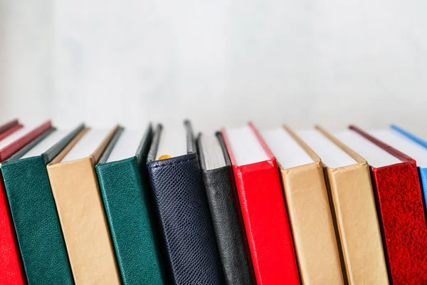 Stack of books on light background