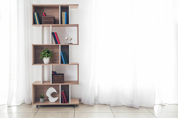 Modern interior with shelf unit and books in room