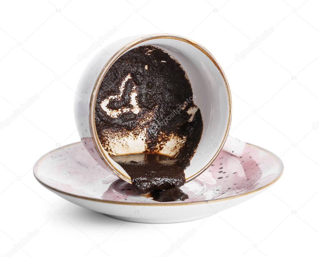 Cup with spent coffee grounds for fortune telling on white background