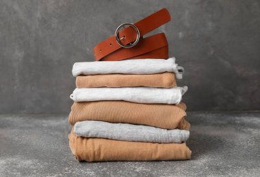 Arkaplanda kemer olan şık kıyafetler yığını