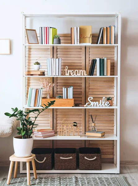 Shelf unit with books and decor in interior of room
