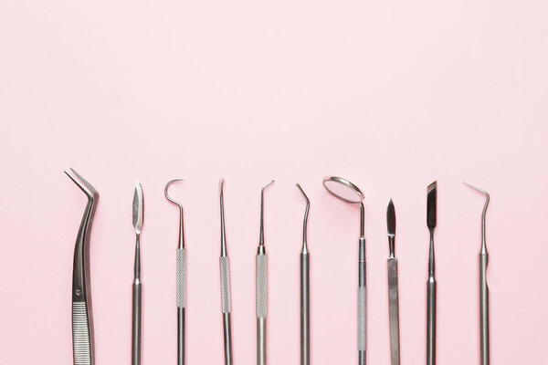 Dentist's tools on color background