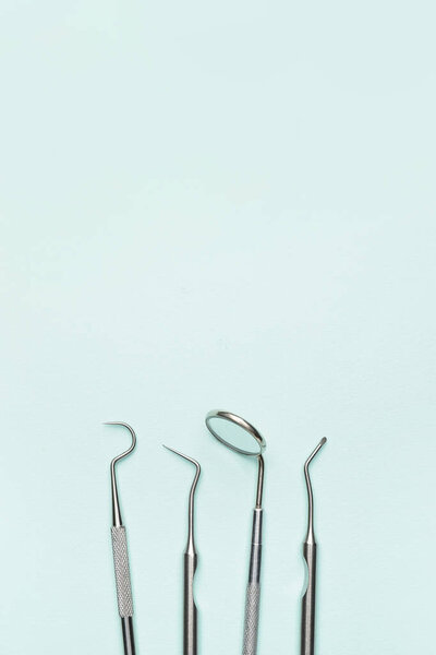 Dentist's tools on color background