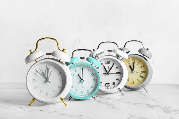 Different Alarm Clocks Light Background — Stock Photo, Image