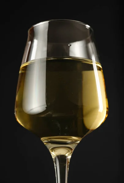 Glass of wine on dark background, closeup