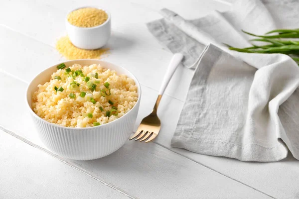 Bowl Tasty Couscous Green Onion Light Wooden Background — Stock Photo, Image