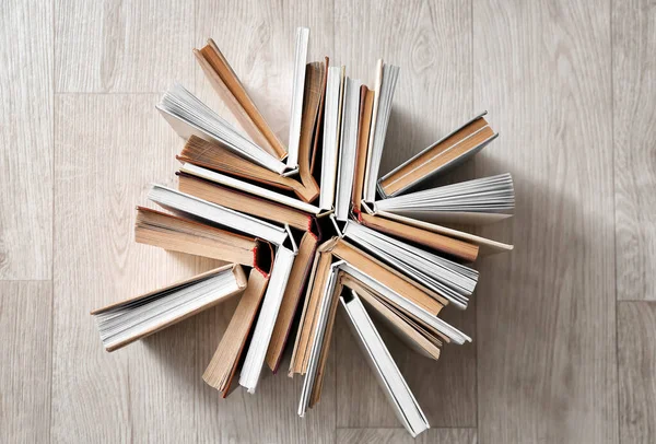 Stack of books on light wooden background