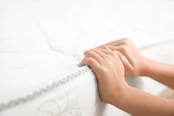 Little Girl Touching Comfortable Mattress Closeup — Stock Photo, Image
