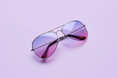 Renkli arkaplanda şık güneş gözlükleri