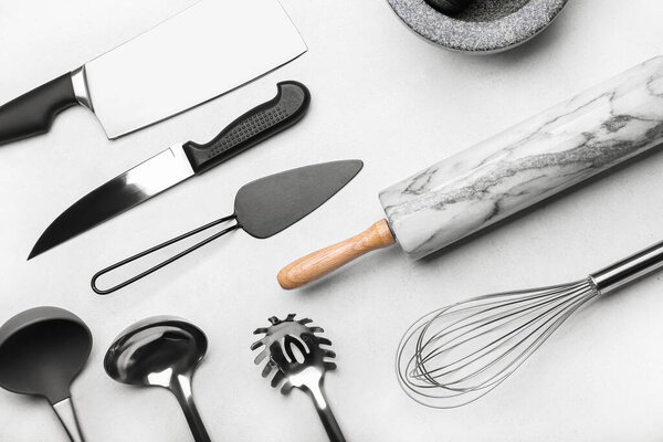 Set of kitchen utensils on light background