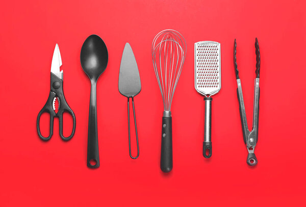 Set of kitchen utensils on color background