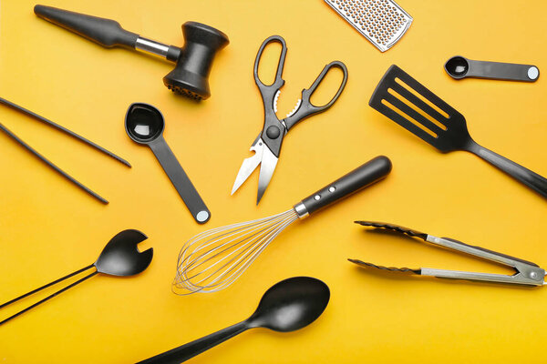 Set of kitchen utensils on color background