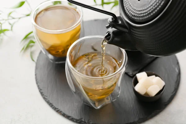 Pouring Green Tea Teapot Cup Light Background Closeup — Stock Photo, Image
