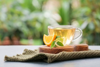 Cup of green tea on table outdoors