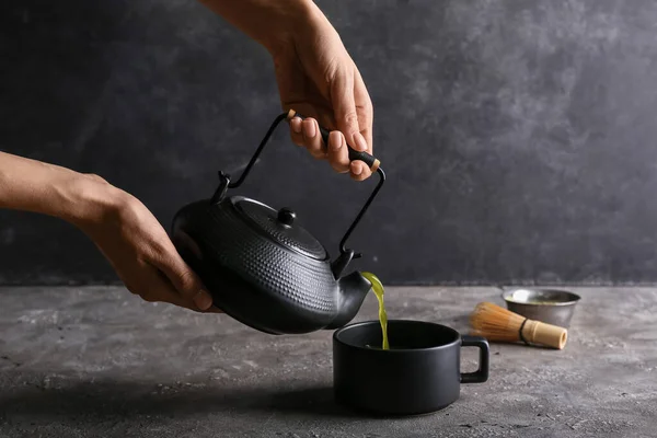 Woman Pouring Matcha Tea Teapot Cup Dark Background — Stock Photo, Image