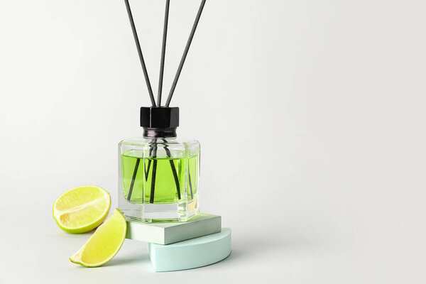 Reed diffuser with lime on light background