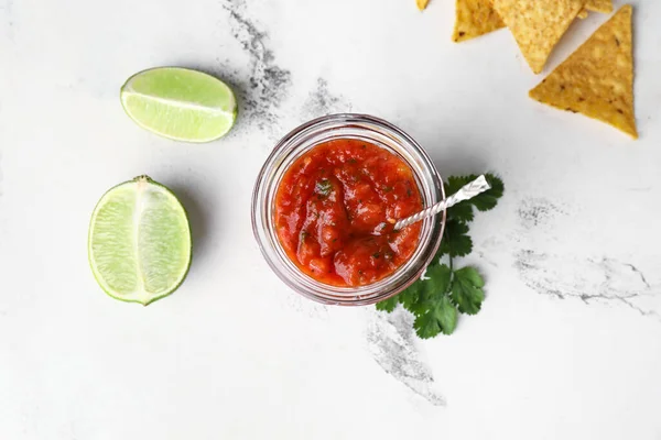 Glass Jar Tasty Salsa Sauce Ingredients Nachos Light Background — Stock Photo, Image