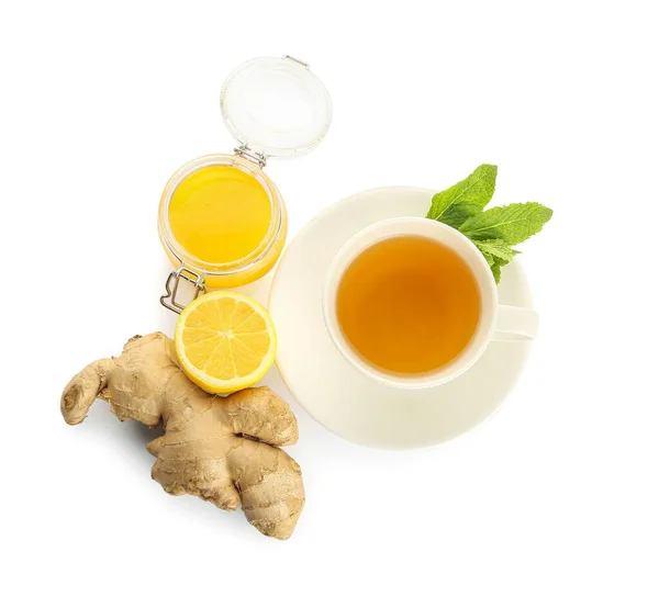 Cup of tea with ginger, honey and lemon on white background