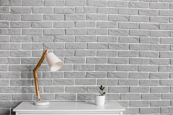 Chest Drawers Houseplant Lamp Brick Wall Room — Stock Photo, Image