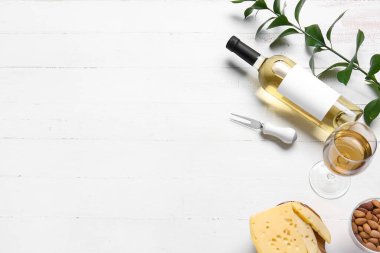 Beyaz ahşap arka planda şarap şişesi olan kompozisyon