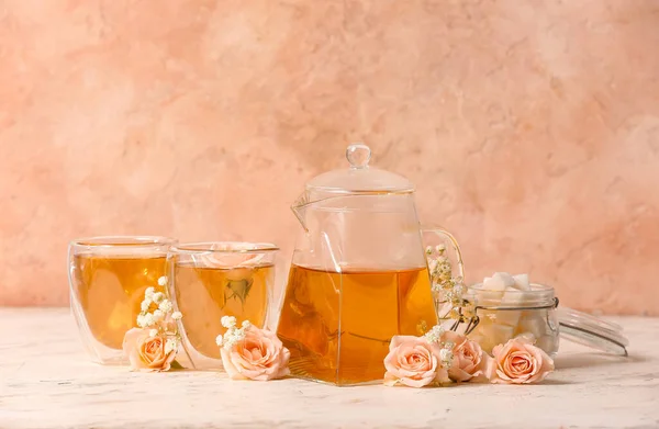 Teekanne Mit Heißem Tee Gläsern Und Blumen Auf Farbigem Hintergrund — Stockfoto