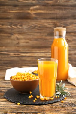 Masada bir bardak sağlıklı deniz dikeni suyu.