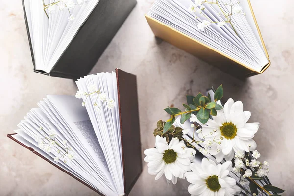 Books with floral decor on grunge background